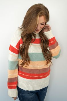 Embrace the cozy charm of autumn with our *Autumn Breeze Sweater*. Crafted from 100% polyester, this sweater is designed to keep you warm and comfortable without compromising on style. The vibrant stripes in rich earthy tones make it a perfect match for your favorite pair of jeans or leggings. With a relaxed, true-to-size fit, this sweater is available in sizes ranging from Small to 2X, ensuring a flattering look for everyone. Whether you're sipping pumpkin spice lattes or taking a stroll throug Cozy Striped Sweater For Layering, Cozy Striped Sweater For Fall, Trendy Horizontal Stripe Sweater For Winter, Trendy Horizontal Stripe Winter Sweater, Trendy Winter Sweater With Horizontal Stripes, Fall Striped Soft Knit Sweater, Multicolor Fall Sweater For Layering, Multicolor Sweater For Fall Layering, Striped Soft Knit Sweater For Fall