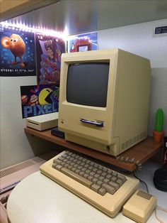 an old computer sitting on top of a desk