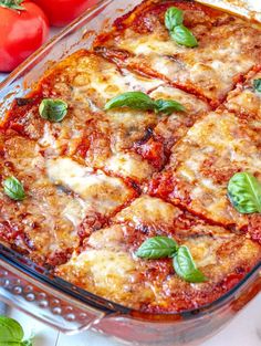 a casserole dish is shown with tomatoes and basil