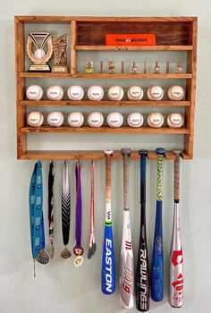 a wooden rack with many different types of baseball bats