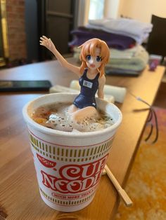 a doll sitting on top of a foamy drink