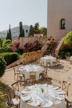 an outdoor dining area with tables and chairs set up for formal function in the sun