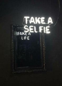 there is a neon sign that says take a selfie