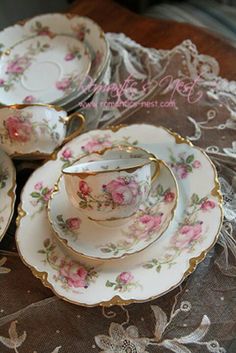 three tea cups and saucers on a table