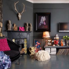 a living room filled with furniture and pictures on the wall next to a fire place