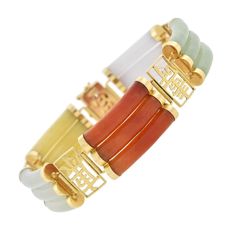 A fun and unique jade bracelet from the 1960s era! Crafted in 14kt yellow gold, this bold piece features an alternating design of multi-colored jade and open Chinese characters. The colorful jade links are comprised of three curved bars, each ending in a polished gold cap. The jade varies in color, including milky lavender, two shades of green, burnt orange, and soft yellow, all displaying rich marbling throughout. The gold connecting links are rectangular in shape and each features an open wire Silver Link Bracelet, Gold Caps, Gold Border, Sapphire Bracelet, Jade Bracelet, Jade Carving, Jade Jewelry, Bracelet Crafts, Silver Filigree