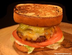 a grilled cheeseburger with tomato and lettuce