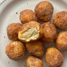 a white plate topped with donuts covered in powdered sugar