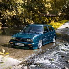 a blue car is driving through some water