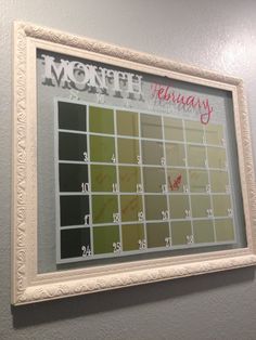 a white framed calendar hanging on the wall