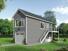 a two story garage with a loft above it