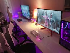 two computer monitors sitting on top of a desk next to a keyboard, mouse and monitor