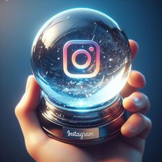 someone holding up a glass ball with the instagram logo on it