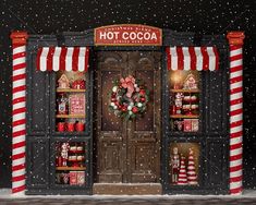 a store front decorated for christmas with red and white striped awnings on it