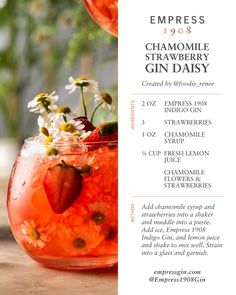 an image of a drink with strawberries and flowers in the glass on the table