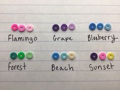 four different colored buttons on lined paper with words describing the names of each button in front of them