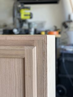 a close up of a wooden door in a kitchen