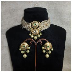 Sabyasachi Inspired Green Kundan Choker features a blend of emeralds, pearls, and Polki stones set in antique gold. The Jadau craftsmanship adds a regal touch, making it a stunning statement piece. Perfect for enhancing traditional and modern ensembles with its exquisite design and elegance..  *𝐏𝐑𝐎𝐃𝐔𝐂𝐓 𝐃𝐄𝐓𝐀𝐈𝐋* * Material: Brass * Plating: Gold Plated * Stone:  Semi Precious CZ Diamond, Kundan, Polki & Green Beads *𝐃𝐈𝐌𝐄𝐍𝐒𝐈𝐎𝐍𝐒* *Necklace* * Weight:  37 gm Each * Length:-8.2 Elegant Kundan Beaded Choker, Formal Kundan Pearl Necklace With Meenakari, Traditional Meenakari Choker For Formal Occasions, Vintage Jeweled Jewelry For Festive Season, Vintage Jeweled Festive Jewelry, Festive Vintage Jeweled Jewelry, Antique Kundan Bridal Necklace Chandbali Style, Antique Kundan Bridal Necklace In Chandbali Shape, Antique Kundan Chandbali Bridal Necklace