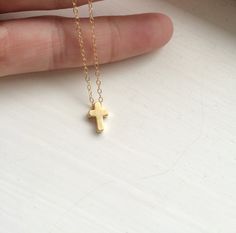 "A tiny gold cross hangs from a shiny, petite gold filled chain. This Tiny Gold Cross Necklace is a simple and light and makes a perfect necklace for everyone. This is a perfect necklace for layering, and to wear every day. -Details Length for necklace - Select length 13 to 24\" - choose the length of necklace from the drop down menu Cross measures approximately 1/2\"L x 1/4\"W, 16k gold plated Chain - 14kt Gold Filled The gold cross is gold dipped over brass -How to Order Please select the chok Easter Necklace, Cross Necklace Gold, Light Necklace, Tiny Cross Necklace, Double Horn Necklace, Luck Necklace, Good Luck Necklace, Silver Cross Necklace, Gold Filled Necklace