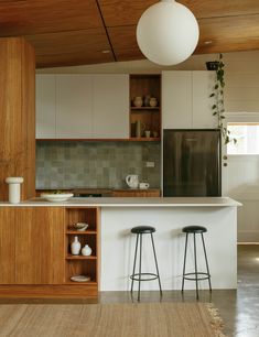 two stools are in front of the kitchen counter