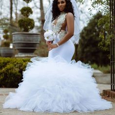 a woman in a wedding dress posing for the camera