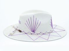 White Palm Straw Hat with Purple TCU Inspired Design on Brim by Corazon Playero. Custom designed and hand made hats by artisans in San Jose Del Cabo, Mexico. These hats are one size fits most with an elastic band inside to add comfort and fit for all head sizes. Each hat has a 3-4 week turnaround. Please note, all hats come with natural braid unless custom braid is purchased. White Artisan Hat With Short Brim, Artisan White Hat With Short Brim, White Handmade Short Brim Hat, Handmade White Bucket Hat, Handmade White Panama Hat With Short Brim, White Artisan Sun Hat With Flat Brim, White Handmade Adjustable Panama Hat, Artisan White Sun Hat With Flat Brim, Artisan White Hat For Vacation