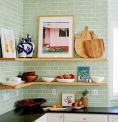 the kitchen is clean and ready to be used for cooking or eating, with green tiles on the walls