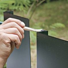 a man is holding a paintbrush in his hand