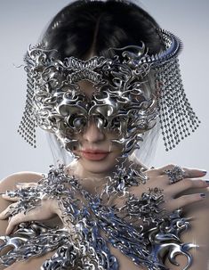 a woman with silver jewelry on her face and hands