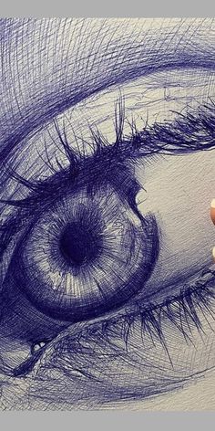 someone is drawing an eye with colored pencils