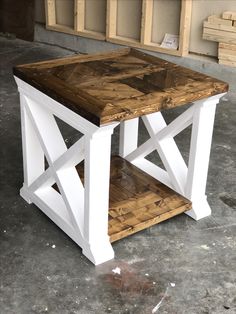 a wooden table sitting on top of a cement floor