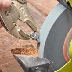 a person using a grinder to cut metal with a circular sawtoothing tool