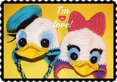 two crocheted hats with large eyes and big beaks, one is wearing a hat