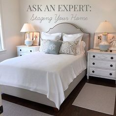 a bedroom with a white bed and two nightstands