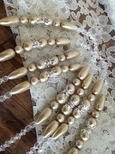 some pearls are laying on top of lace