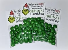 green candy candies in cello bags with santa's hat on the top and christmas stickers above them