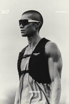 a man with sunglasses on his head is standing in front of the camera and wearing a vest