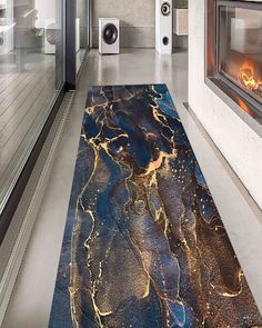 a large blue area rug in front of a fire place