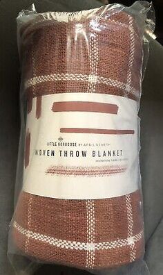 the brown and white plaid blanket is wrapped in plastic