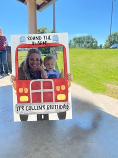 a woman holding a child in a bus shaped photo frame with the words sound the alarm it's collin's birthday