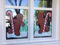 two windows decorated with gingerbreads and candy canes