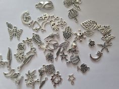 Silver tone mixed charms. Material: Zinc alloy Quantity: 50 pcs Size: mixed 2.9 cm, 1.6 cm, 1.5 cm, 1.8 x 0.5 cm, 1 cm Handmade Silver Alloy Charm Necklaces, Handmade Silver Charm Necklace In Alloy, Nickel-free Silver Charm Necklace, Silver Metal Charms For Jewelry Making, Silver Metal Charm Necklaces, Silver Vintage Charm Metal Charms, Silver Charm Necklaces With Vintage Metal Charm, Silver Metal Charms With Vintage Detail, Silver Charm Necklace With Vintage Metal Charm