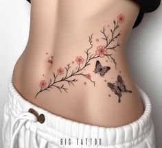 a woman's stomach with flowers and butterflies on the side, as if it were tattoos