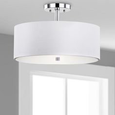 a white drum light hanging from the ceiling