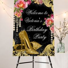 a welcome sign for a birthday party with high heels and roses on the front in gold