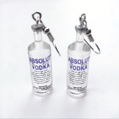 two miniature vodka bottles attached to each other on a white background with the words absolut vodka printed on them