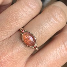 The sparkle of this Indian Sunstone is captivating and colors are vibrant. Set in 14k yellow gold with accent beads and a freeform sterling silver band Emily chose a pair of bright orange sapphires to complete this sunny piece. Approximate stone size: 11.5mm x 8.5mm Approximate Carat Weight: 2.3 ct Mohs Stone Hardness: 6 This one of a kind piece is handmade with love in Emily's Hudson Valley studio. If you have questions about sizing, shipping or need help deciding on your perfect piece please r Orange Sapphire Ring, Orange Sapphire, Local Jewelry, Sterling Silver Bands, Hudson Valley, Bright Orange, Silver Band, Sapphire Ring, Stone Color