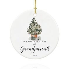 a white ornament with a christmas tree on it