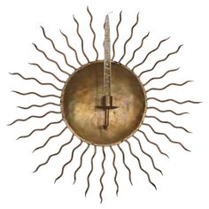 a metal sun with a cross on it