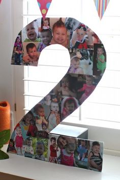 the number two is decorated with photos of children and birthday balloons in front of a window